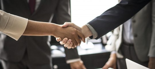 Business people shaking hands in a meeting room Business people shaking hands in a meeting room